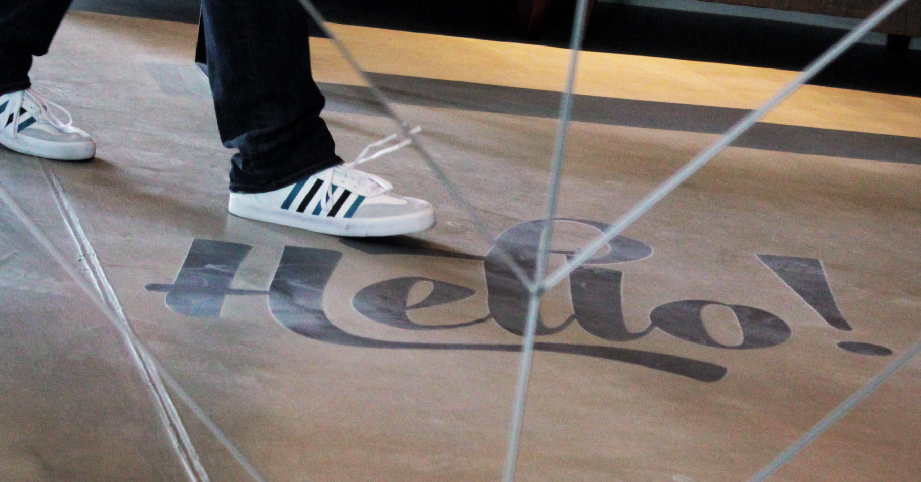 Sneakers walking on floor hello sign